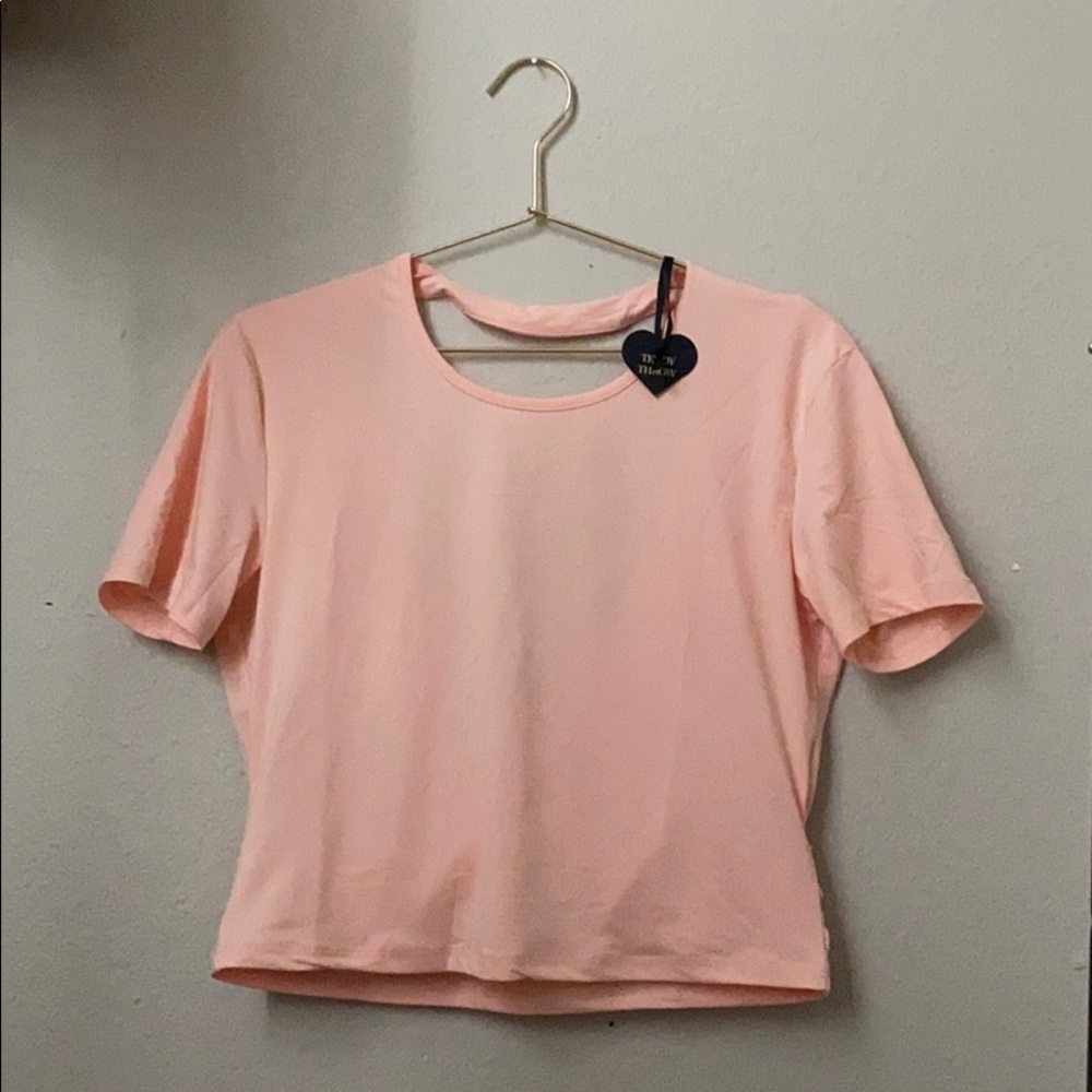 light pink active wear top with cut out back.